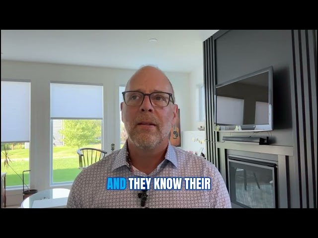 man in glasses talking to computer screen